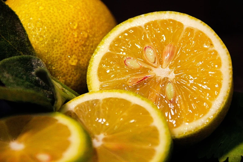 a close up of an orange cut in half, a picture, by Dietmar Damerau, pexels, arms of lemons, yellow and greens, molten, emerald