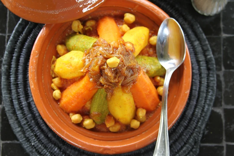 a close up of a bowl of food with a spoon, inspired by Riad Beyrouti, flickr, vegetable, caramel, stuffed, a quaint