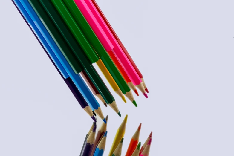 a group of colored pencils sitting next to each other, a color pencil sketch, crayon art, view from below, sharp photo, low angle photo, stock photo