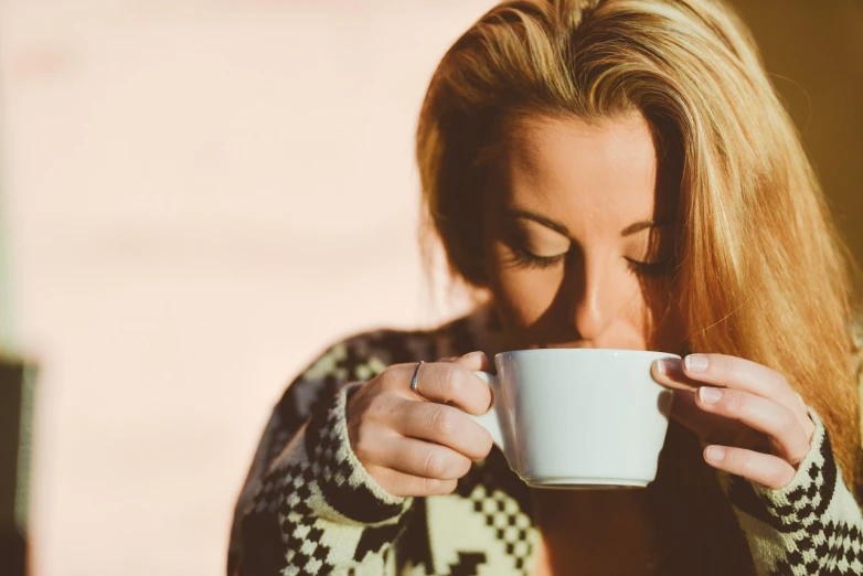 a woman is drinking a cup of coffee, by Karl Buesgen, pexels, romanticism, california;, retro effect, mr robert is drinking fresh tea, blonde women