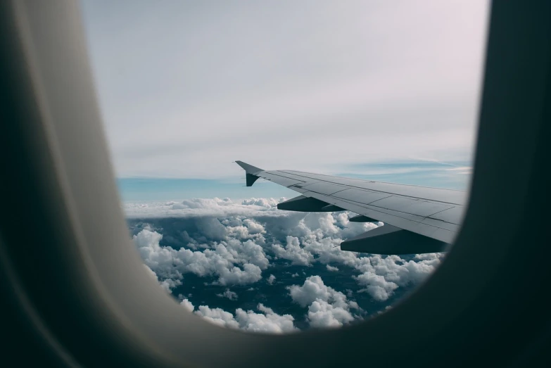a view of clouds from an airplane window, a picture, minimalism, jet wings on the back, boeing 737 cabin, on the ground, trim