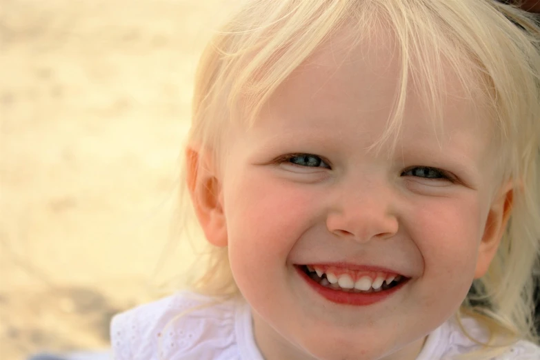 a close up of a child smiling at the camera, a picture, a girl with blonde hair, smaller mouth, toddler, sharp detail