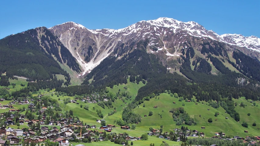 a view of a small town in the mountains, a picture, by Werner Andermatt, gigantic mountains, in summer, stunning ski, wikimedia commons