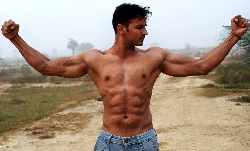 a man flexing his muscles on a dirt road, by Rajesh Soni, pexels, realism, very sexy pose, half body cropping, with abs, symmetrical face and body