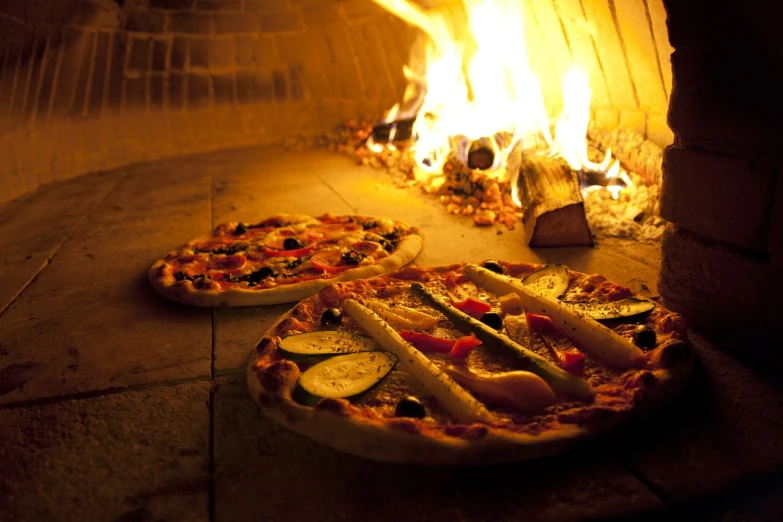 two pizzas sitting on top of pizza pans in front of a fire, shutterstock, fine dining, joseph todorovitch ”, full length shot, high quality image”