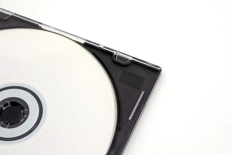 a close up of a compact disk on a white surface, minimalism, high detail product photo, portlet photo, mouse photo, jewel case