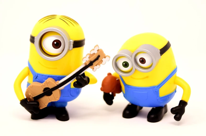 a couple of minion figurines standing next to each other, a picture, by Tom Carapic, pexels, playing guitars, avatar image, banner, squishy