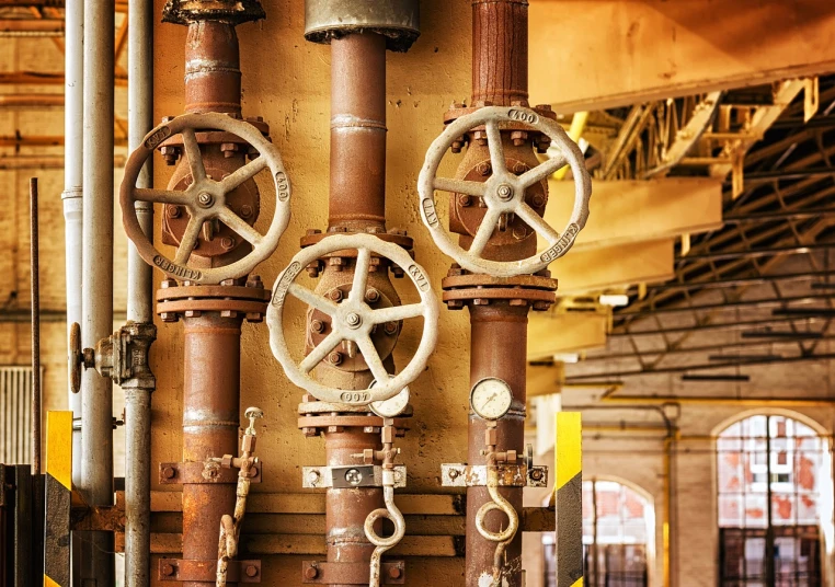 a bunch of pipes that are next to each other, by John Murdoch, shutterstock, assemblage, waterwheels, warm and joyful atmosphere, dials, rusted walls
