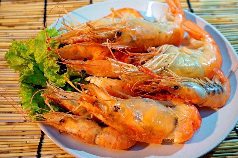 a white plate topped with shrimp and lettuce, a portrait, by Basuki Abdullah, shutterstock, dau-al-set, crabs, warm coloured, thai, closeup photo