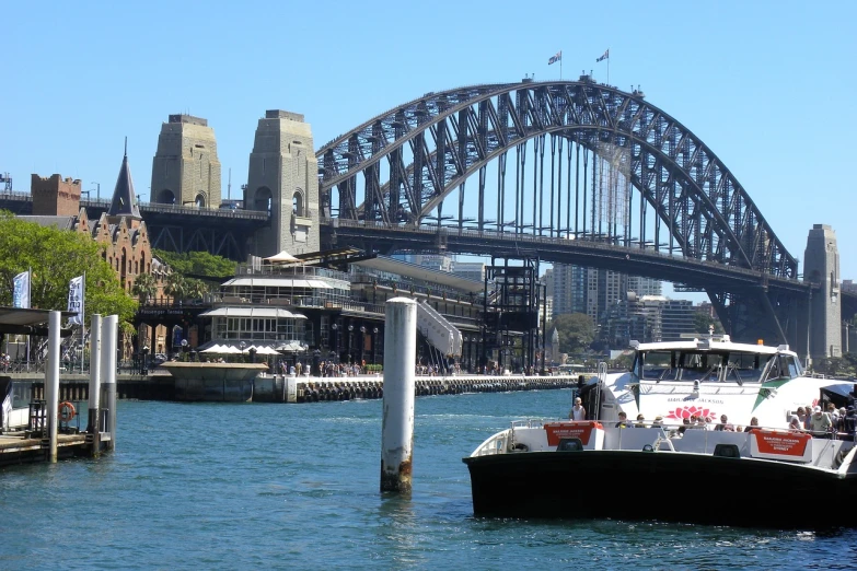 a boat in the water with a bridge in the background, a picture, inspired by Sydney Carline, hurufiyya, viewed from the harbor, huge success, information, tony roberts