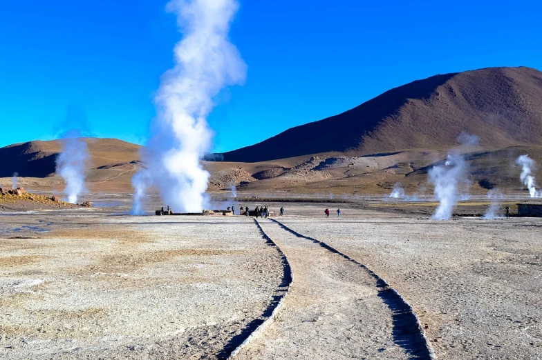 a group of people that are standing in the dirt, a photo, shutterstock, land art, geysers of steam, on a bright day, amagaitaro, 2 0 2 2 photo