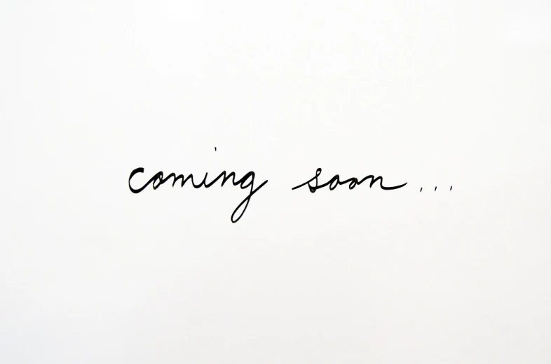 a white wall with the words coming soon written on it, by Pamela Drew, tumblr, happening, black ink on white background, in style of mike savad”, website banner, cute:2