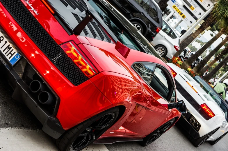 a red sports car parked on the side of the road, a photo, by Alexander Fedosav, bold lamborghini style, samurai vinyl wrap, close up angle, many angles