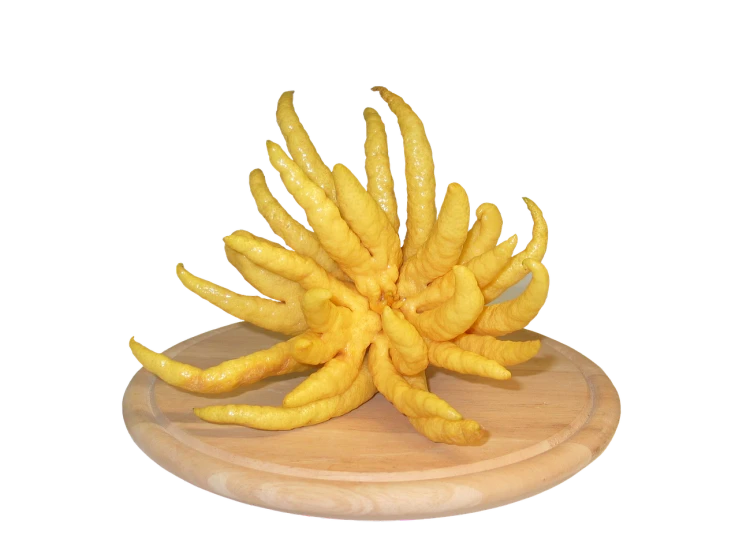 a pile of yellow chili sitting on top of a wooden cutting board, a surrealist sculpture, by Kishi Ganku, trending on zbrush central, new sculpture, jungle fruit, gnarled fingers, full - view, nine tails