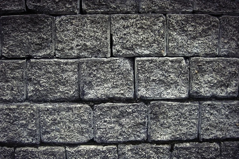 a black and white photo of a brick wall, by Yasushi Sugiyama, unsplash, ((rocks)), texturized, monochrome color, celebration