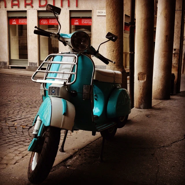 a motor scooter parked on the side of a street, by Davide Sasselli, flickr, turqouise, in retro colors, italian masterpiece, cut