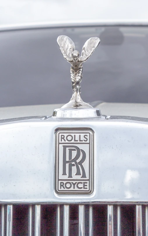 the hood ornament of a rolls royce car, an art deco sculpture, instagram, productphoto, royal workshop, engraved, satin silver