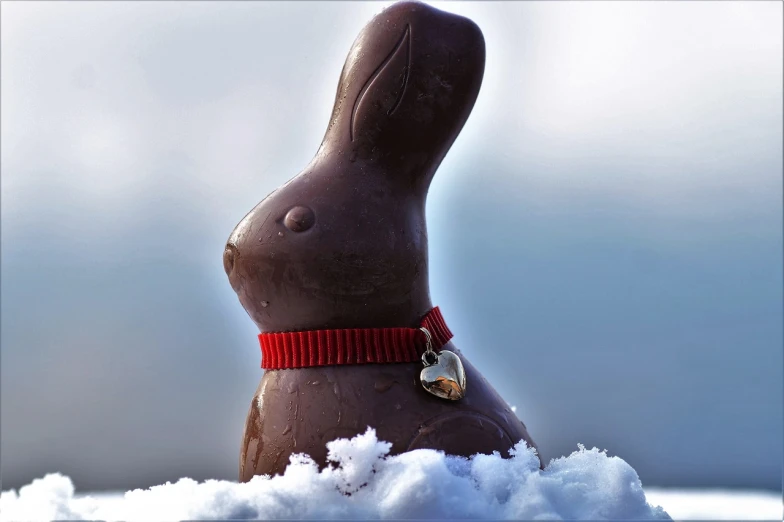 a chocolate bunny sitting on top of a pile of snow, a picture, romanticism, an extremely high quality hd, egg, dark-skinned, ham
