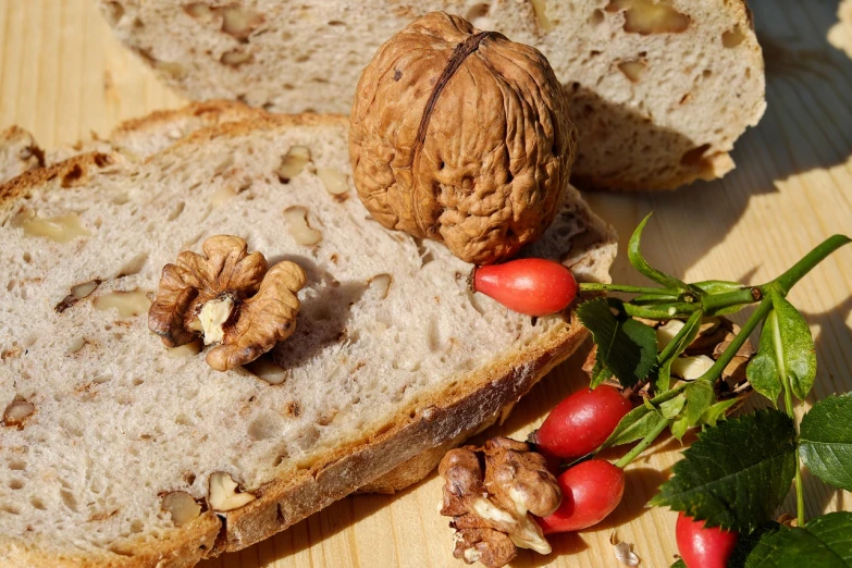 a piece of bread sitting on top of a wooden table, a still life, by Dietmar Damerau, pixabay, walnuts, “berries, 1970s photo