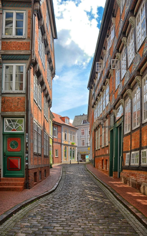 a cobblestone street in an old european city, a photo, by Juergen von Huendeberg, shutterstock, lower saxony, wooden buildings, jugendstil, deep colours. ”