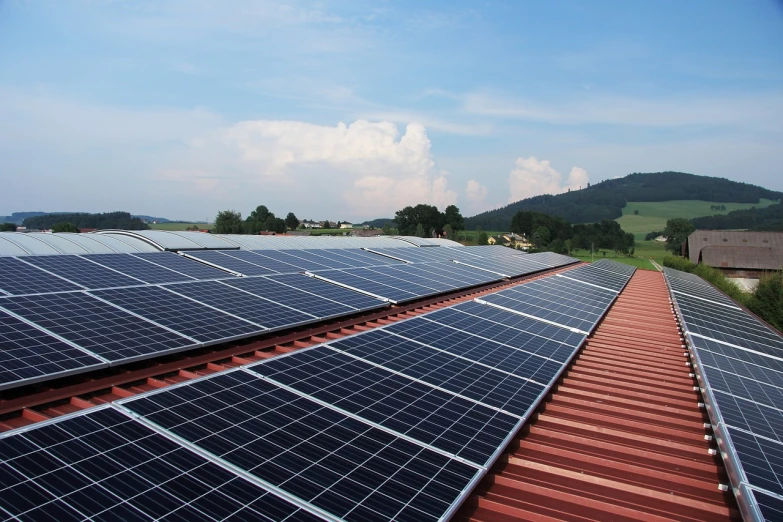 a row of solar panels on the roof of a building, pexels, metal panels, farm, dalle 2 reference, summer light