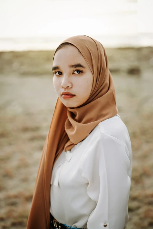 a woman in a hijab poses for a picture, a picture, by Basuki Abdullah, shutterstock, realism, golden hour closeup photo, white scarf, girl with brown hair, head and waist potrait