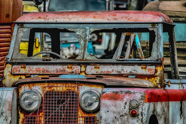 an old rusted truck sitting in a parking lot, by Richard Carline, pexels contest winner, photorealism, land rover defender, details and vivid colors, the cars have faces, 🦩🪐🐞👩🏻🦳