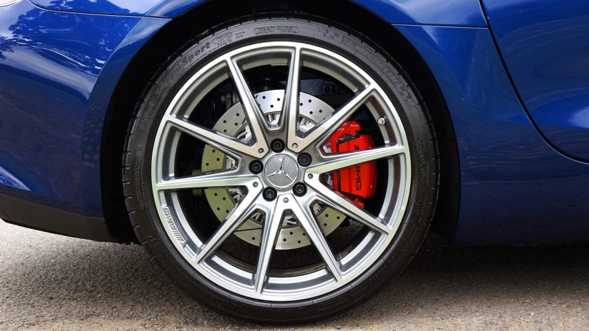 a close up of a tire on a blue sports car, mercedez benz, with accurate features, blue colors with red accents, with lots of details