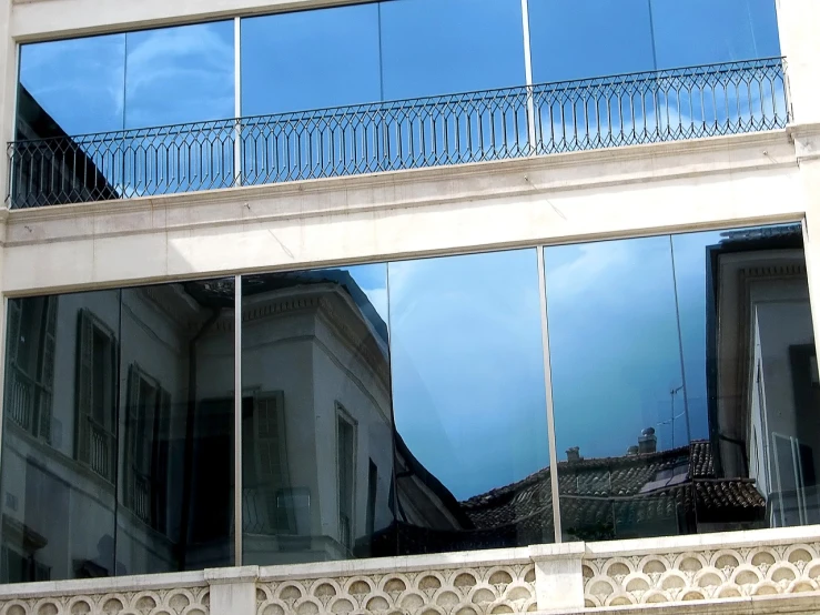 a clock that is on the side of a building, a picture, inspired by Leandro Erlich, flickr, modernism, reflections on a glass table, réunion des musées nationaux, nice weather, panoramic anamorphic