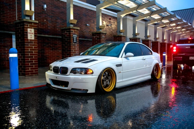 a white car parked in front of a building, by Jason A. Engle, flickr, renaissance, bmw, vibrant but dreary gold, wide body, big arches in the back