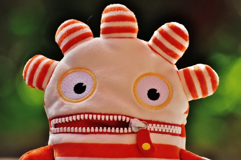 a close up of a stuffed animal with a zipper, inspired by Sam Havadtoy, neo-dada, cute monster character design, macro image!!!!!, stripes, very surprised