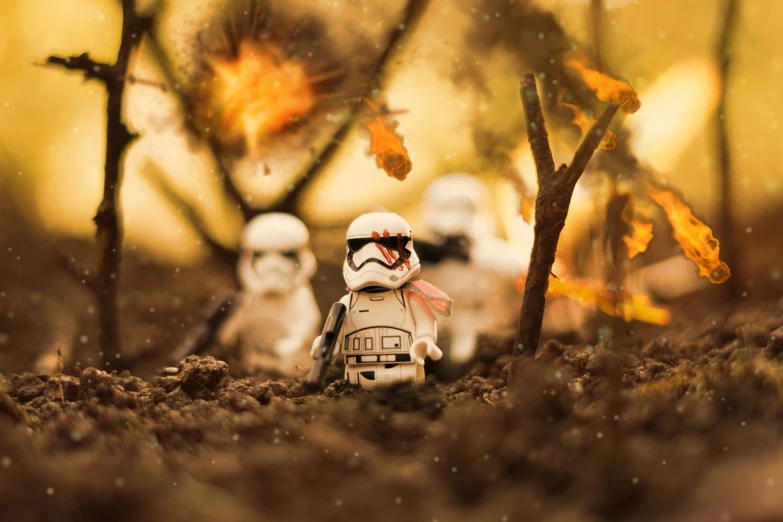 a group of star wars figurines sitting on top of a pile of dirt, a tilt shift photo, inspired by Edo Murtić, autum, [explosions and fire], portrait of a stormtrooper, amongst foliage