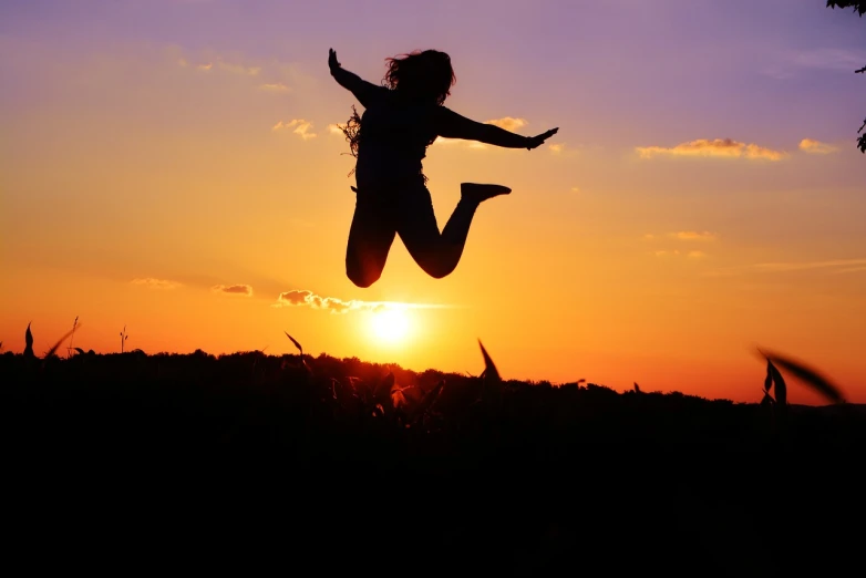 a person jumping in the air at sunset, shutterstock, happy girl, stock photo, well done picture high quality, black