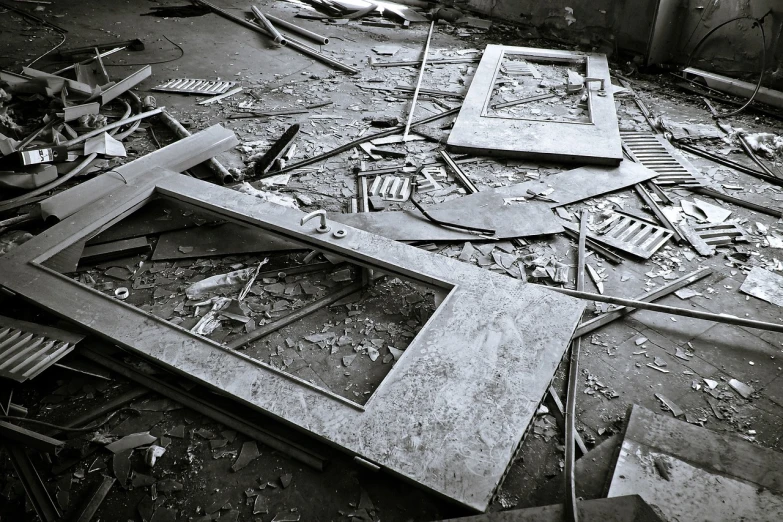 a black and white photo of a pile of junk, a photo, doors, broken glass photo, metal floor, lost place photo