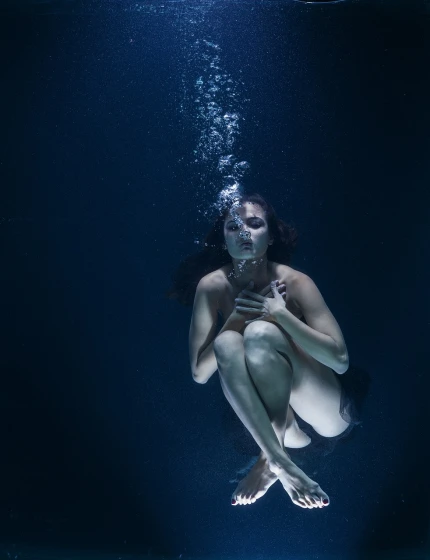 a woman under water using a cell phone, a portrait, unsplash, conceptual art, shot at dark with studio lights, medium format. soft light, levitating, 2 5 yo