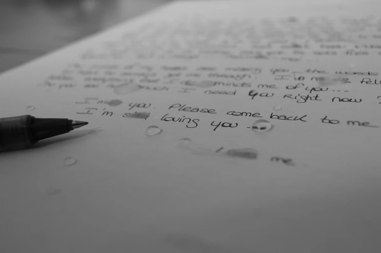 a pen sitting on top of a piece of paper, a black and white photo, pexels, letterism, i love you, tears, back facing the camera, wallpaper - 1 0 2 4
