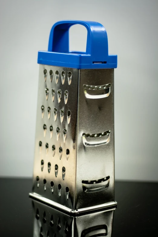 a close up of a grater on a table, a macro photograph, hyperrealism, 4k (blue)!!, high resolution product photo, product introduction photo, full body close-up shot