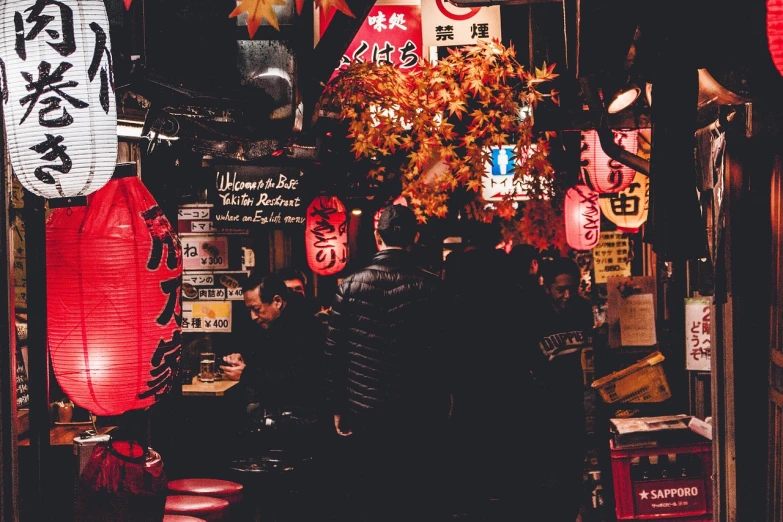 a man that is standing in front of a store, pexels, ukiyo-e, tokyo izakaya scene, chinese new year in shanghai, people at night, red and black color palette