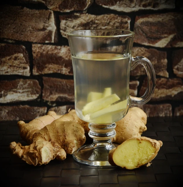 a cup of tea with a slice of ginger next to it, inspired by Wlodzimierz Tetmajer, pixabay, renaissance, absinthe, potato, fitness, jean paul gaultier