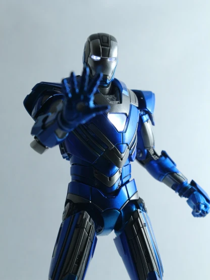 a close up of a toy iron man, inspired by Otto Stark, flickr, monochromatic blue, threatening pose, figma, “hyper realistic