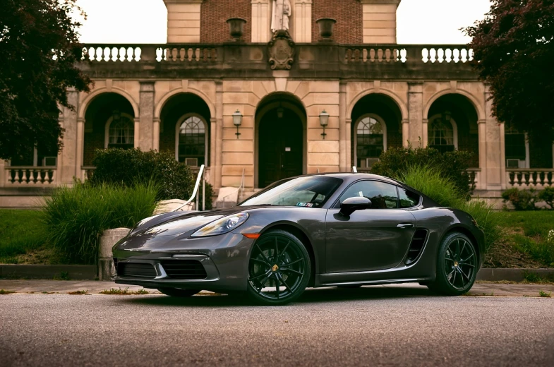 a silver sports car parked in front of a building, inspired by Harry Haenigsen, pexels contest winner, baroque, rhode island, 🕹️ 😎 🔫 🤖 🚬, scorpion, black on black