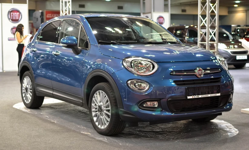 a blue car is on display in a showroom, a portrait, by Carlo Martini, shutterstock, renaissance, with a round face, panini, ape, loadscreen”