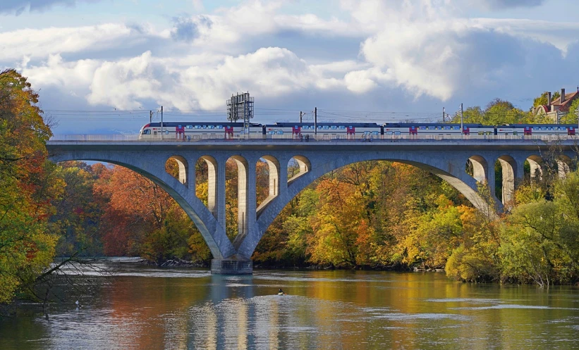 a train crossing a bridge over a river, a portrait, by Karl Stauffer-Bern, flickr, autum, washington dc, today's featured photograph 4 k, jr sc maglev