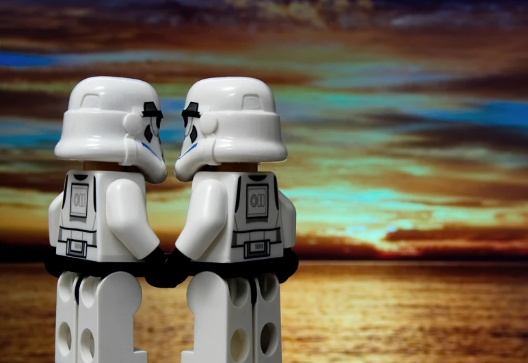 a couple of lego figures standing next to each other, a picture, inspired by Tim and Greg Hildebrandt, flickr, shipfleet on the horizon, stormtrooper, sunset photo, beautiful sci - fi twins