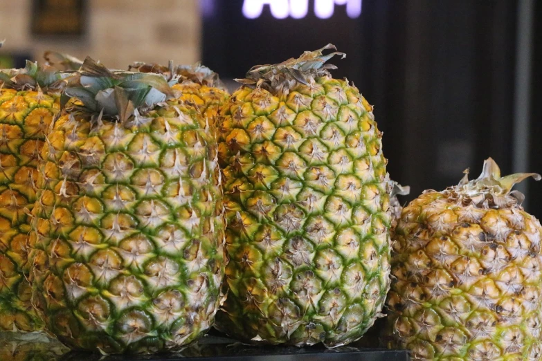 a bunch of pineapples sitting on top of a table, a portrait, img _ 9 7 5. raw, octa 8k, at the counter, highly detailed -