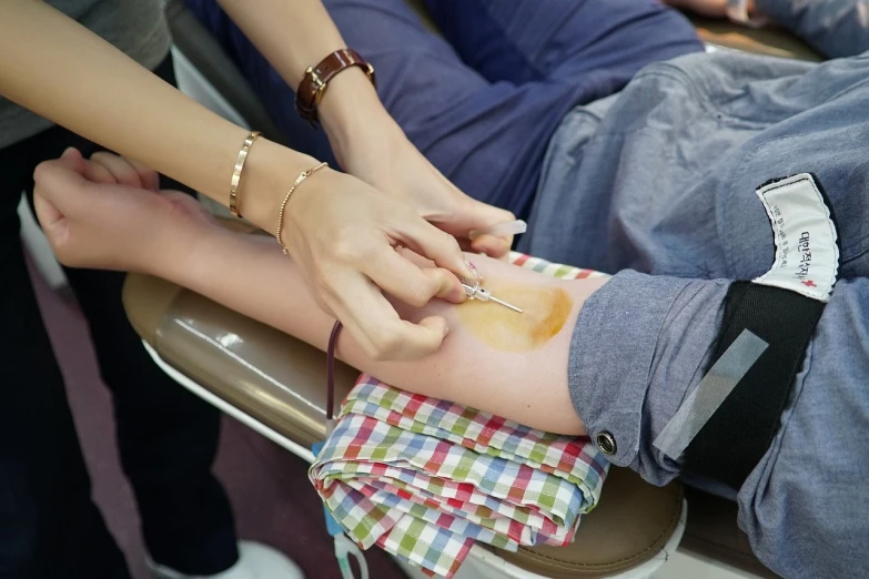 a close up of a person with a needle in their hand, a picture, shutterstock, sea of blood, with a bright yellow aureola, iv drip, tournament