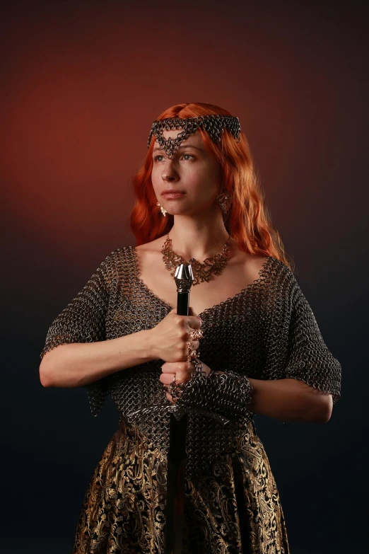 a woman in a medieval dress holding a sword, beautiful redhead woman, chainmail, girl with warship parts, photo of a hand jewellery model