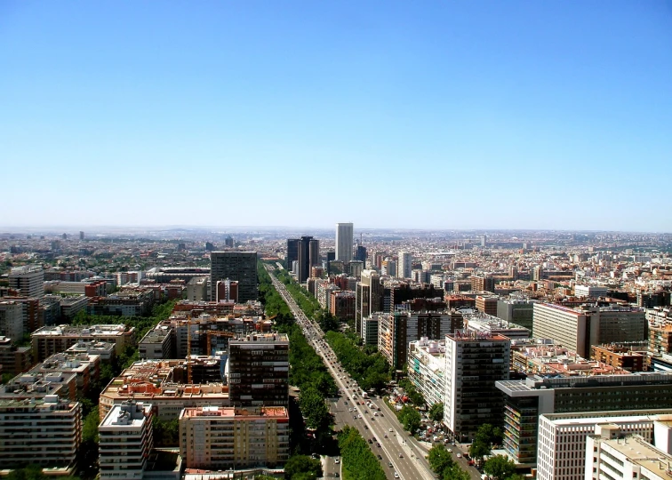 a view of a city from the top of a building, by Luis Enrique Camej, flickr, madrid. extreme long shot, full - view, ponte 2 5 de abril, wide open city ”