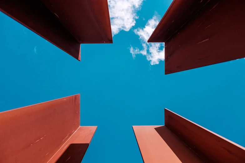 a view from the ground looking up at the sky, an abstract sculpture, by Tobias Stimmer, pexels contest winner, red iron oxide, cube portals, crossing the blue horizon, cross