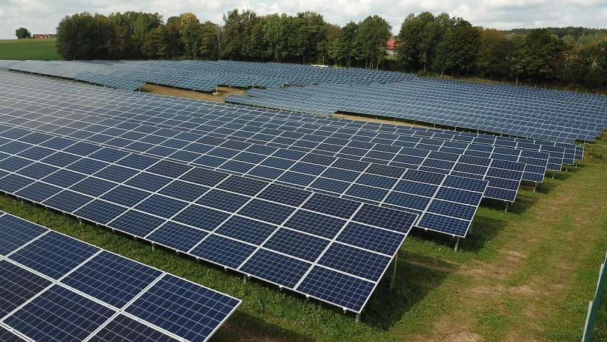 a large array of solar panels in a field, a photo, by Werner Gutzeit, happening, high quality photo, associated press photo, proper shading, subtitles